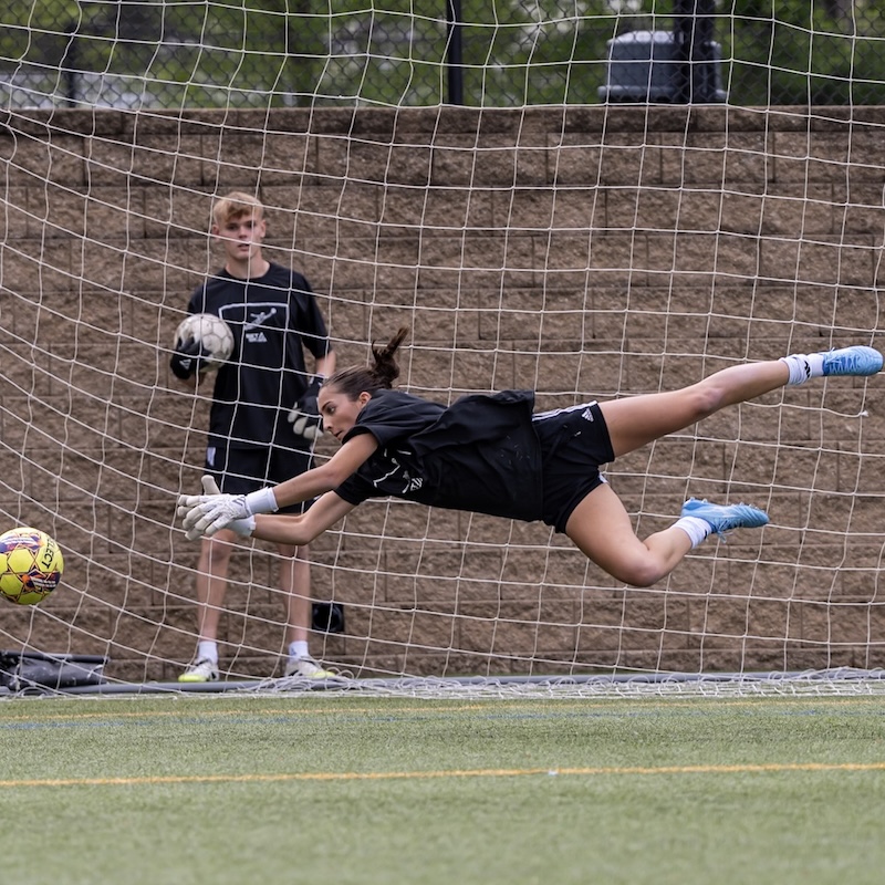 Aviana Owings diving to save a Select ball